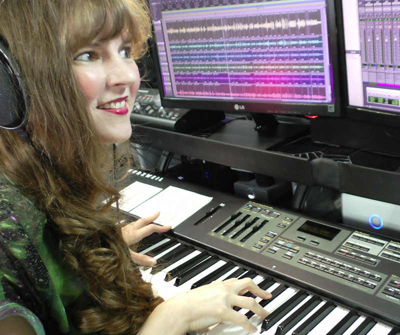 Award-winning video game composer Winifred Phillips, working in her music studio.