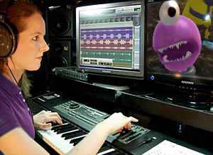 video game music composer Winifred Phillips, working in her studio on the music of The Maw video game.