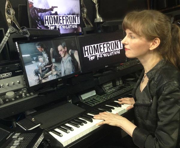 Composer Winifred Phillips, working on music for Homefront: The Revolution in her music studio.
