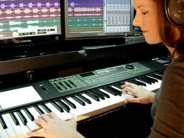 Video game composer Winifred Phillips, working in her music studio.