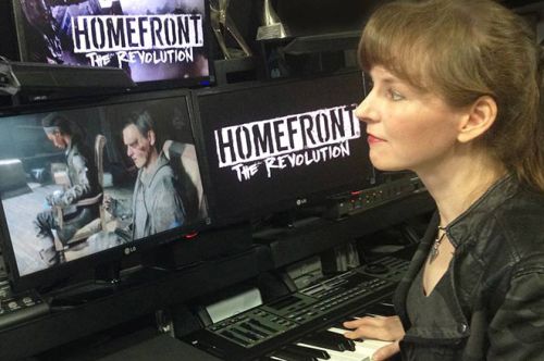 Video game music composer Winifred Phillips working in her studio on the music of the Homefront: The Revolution video game.