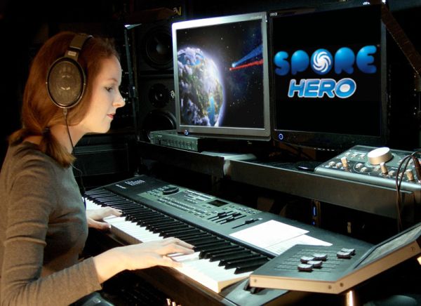 Photo of video game composer Winifred Phillips working in her music production studio.