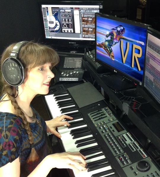 Photo of game composer Winifred Phillips in her music production studio, from the article "Video Game Music Composer: Music and Sound in VR Headphones (Part One)"