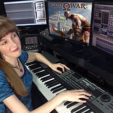 Video game music composer Winifred Phillips working in her studio on the music of the God of War video game.