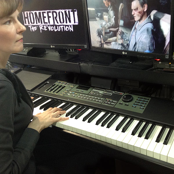 Winifred Phillips (video game composer), working in her studio on the music of the Homefront: The Revolution video game.