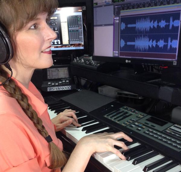 Winifred Phillips (video game composer) working in her music studio.