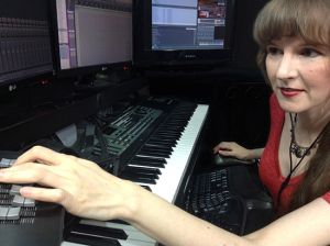 Photo: Winifred Phillips, composer of music for video games, working in her music production studio.