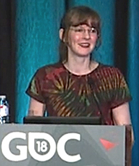 In this article for and about the craft of video game composers, Winifred Phillips is pictured in this photo from her lecture on Virtual Reality given at the popular Game Developers Conference in 2018.