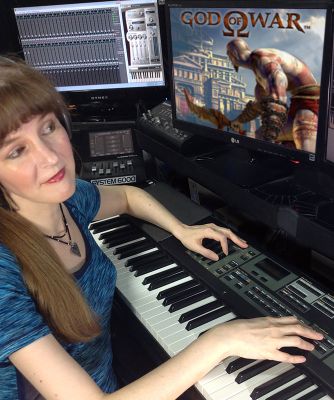 In this article for video game composers, popular game composer Winifred Phillips is depicted in this photo working in her music production studio.