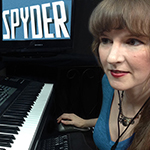 Photo of video game composer Winifred Phillips working in her music production studio on the music of the Apple Arcade game Spyder. Phillips is a frequent writer and speaker on the role of music in games, with multiple lectures given at such venues as the Game Developers Conference (GDC).