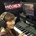 Photo of video game music composer Winifred Phillips, working in her music studio on the score to the Hades' Star video game.