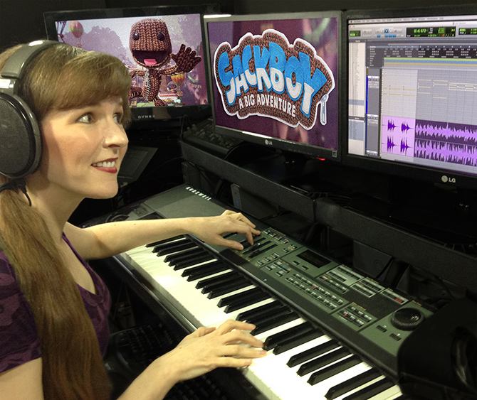 This photo depicts game music composer Winifred Phillips working in her music production studio at Generations Productions LLC on the musical score of the Sackboy: A Big Adventure game from Sumo Digital. Winifred Phillips is an award-winning video game music composer whose credits include games from five of the biggest franchises in gaming (Assassin's Creed, God of War, Total War, LittleBigPlanet, The Sims).